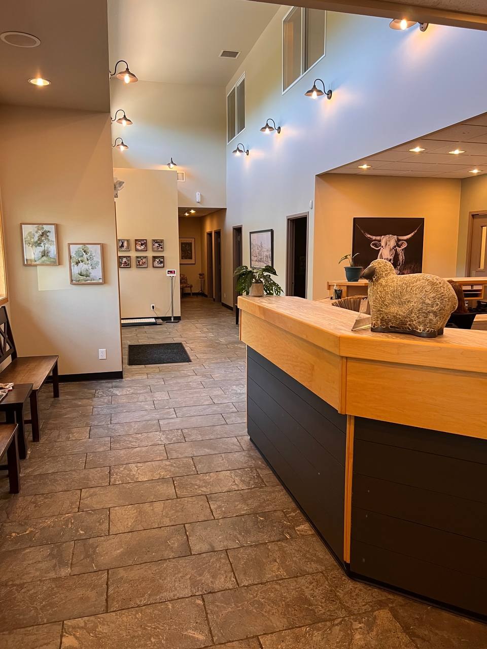 The reception counter under a high vaulted ceiling, with seating in the waiting area