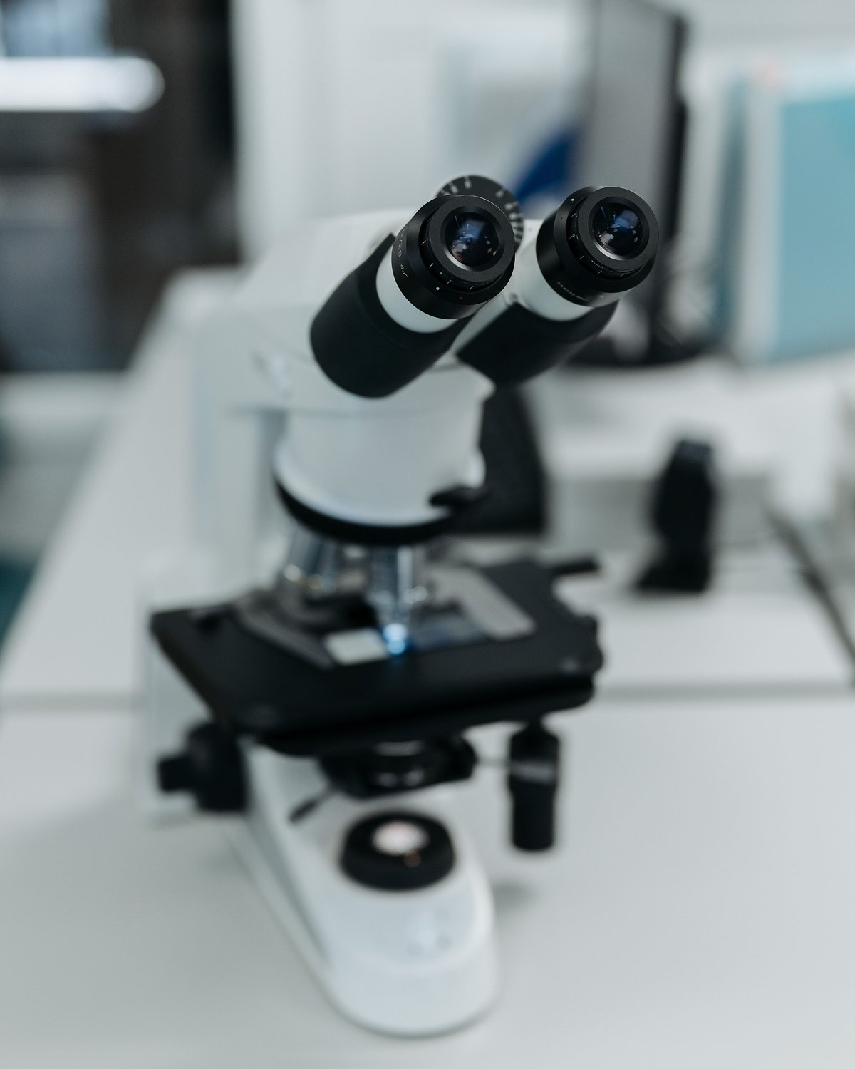 A microscope on a clean white laboratory bench